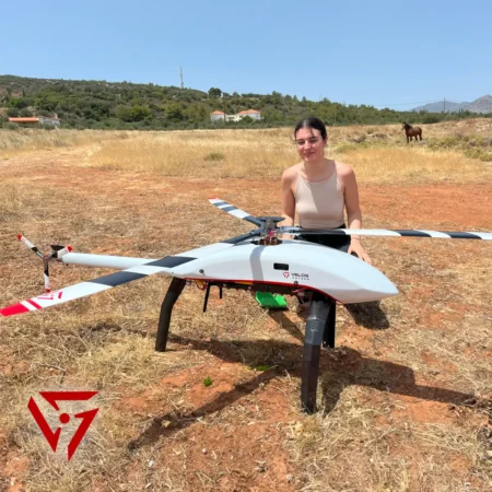 Yasmine, Mechanical Engineer intern at Velos Rotors in Greece, next to a Velos V3 UAV helicopter