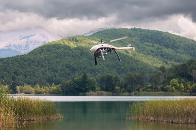 Velos V3 UAV helicopter flying with a RIEGL LiDAR, just one example of the kinds of high-end LiDARs customers can equip on Velos Rotors' aircraft.